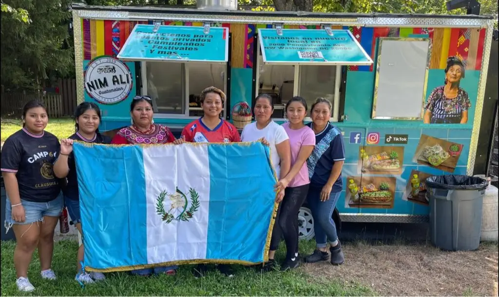 A Nim Ali llegan comensales de todas nacionalidades. Pero cuando se trata de guatemaltecos, siempre hay momento para una foto con la bandera nacional, conversar y sentirse hermanos y hermanas en tierra distante. – SoyMigrante.com REVISTA – SoyMigrante.com REVISTA