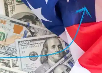 Dinero en billetes de dólares y bandera de EE.UU., símbolo de migración y economía internacional.