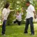 Niños y padres disfrutando en un parque, jugando y sonriendo, promoviendo valores familiares y la importancia de la unión familiar.