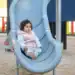 Niña en parque infantil deslizando en tobogán, juego para niños, diversión infantil, espacio de recreo y esparcimiento, infancia y juegos.