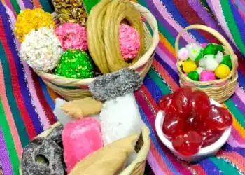 Chuches mexicanas tradicionales en cestas de colores con fondo de tela colorida, ideal para celebrar festividades o compartir dulces típicos en eventos culturales y familiares.