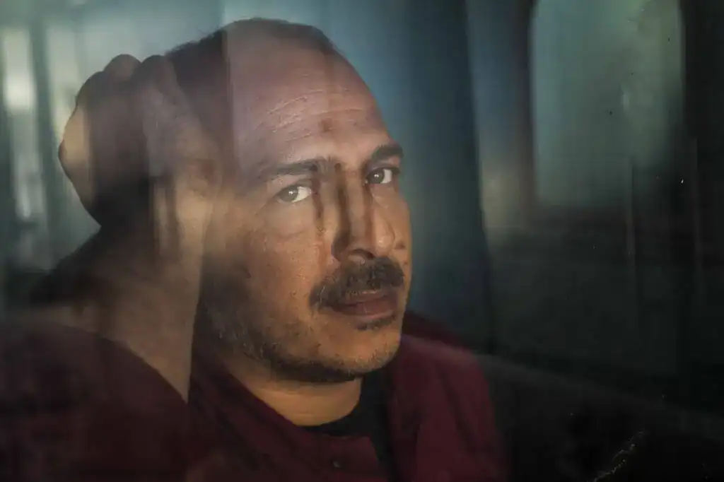 Persona reflexionando sobre migración y experiencias migrantes en un entorno moderno. – SoyMigrante.com REVISTA