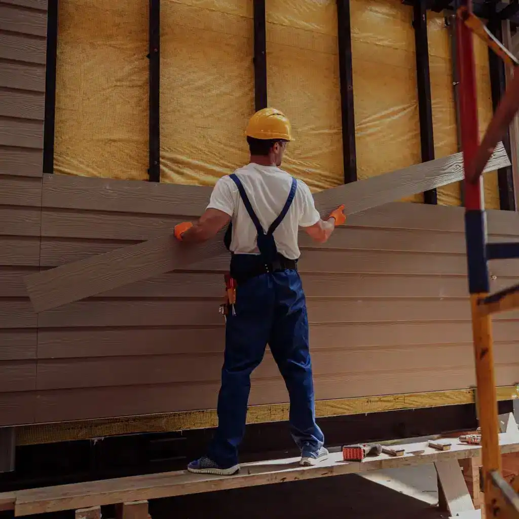 Trabajador de la construcción colocando paneles de madera, porfolio de reformas y trabajos en madera, construcción de interiores y carpintería, enfoque en construcción y renovación del hogar. – SoyMigrante.com REVISTA