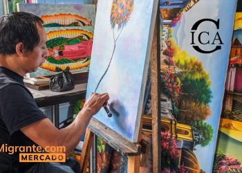 Migrant artist painting a blue-toned canvas at an easel, surrounded by colorful artworks; SoyMigrante.com MERCADO logo bottom left.