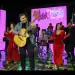 AIMM Malagated Teló Sound en escena con músicos tocando en vivo en un evento cultural y musical.