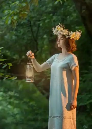 Un mujer con corona de flores sostenido una linterna en un bosque, simbolizando conexión con la naturaleza y espiritualidad. Perfecta para artículos sobre migración, cultura, bienestar y noticias relacionadas.