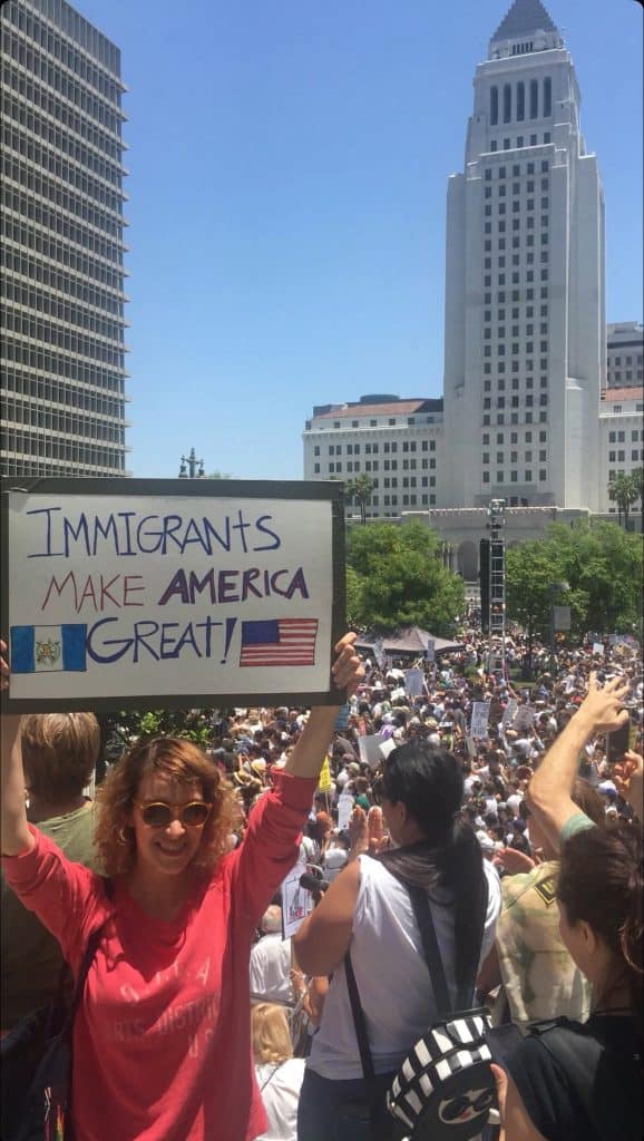 Inmigrantes en manifestación con cartel que dice "Immigrants make America great", en un contexto de protesta y derechos migrantes en Estados Unidos. – SoyMigrante.com REVISTA