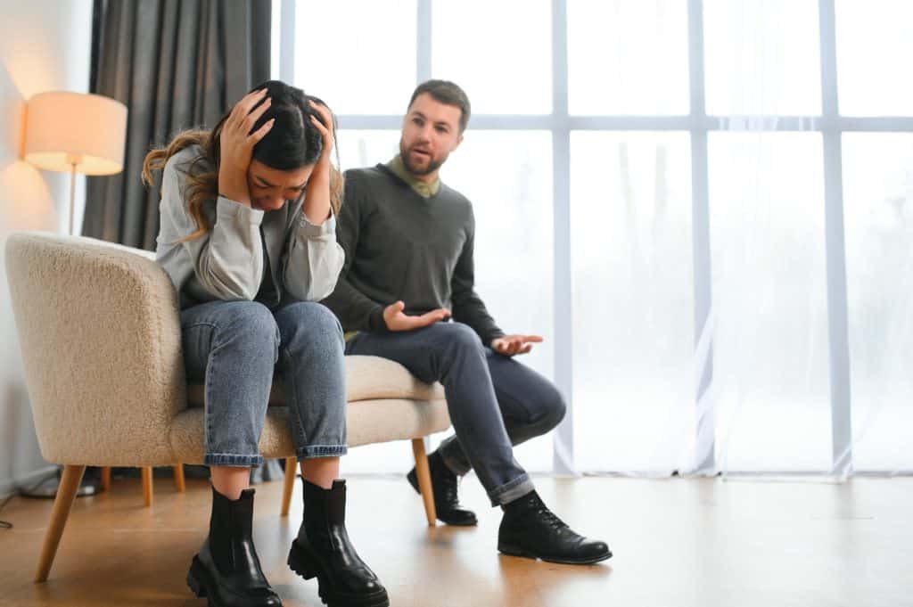 Ansiedad y estrés en migrantes, mujer con dolor en la cabeza en terapia psicológica, apoyo emocional y salud mental en comunidad migrante, comprensión y ayuda en proceso de adaptación. – SoyMigrante.com REVISTA