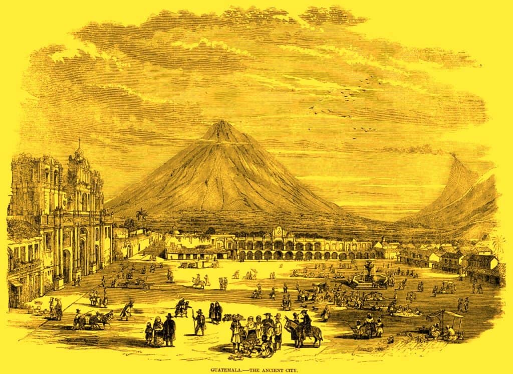 Ancient city of Guatemala with volcano in background, bustling marketplace, colonial architecture, and vibrant community life, illustrating historical and cultural richness. – SoyMigrante.com REVISTA