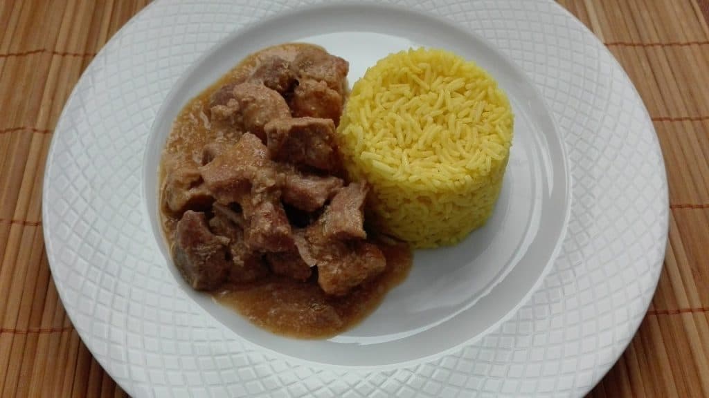 Carne en salsa con arroz amarillo, plato típico mexicano, servido en plato blanco, comida tradicional, gastronomía mexicana, receta casera, deliciosa y nutritiva, comida reconfortante. – SoyMigrante.com REVISTA