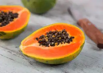 Los superpoderes de la papaya: un fruto que transforma la salud – SoyMigrante.com REVISTA Jugosidad de papaya con semillas negras en una mesa de madera natural, saludable y nutritiva, ideal para quienes valoran la alimentación natural y el bienestar, promoción de recetas y beneficios de frutas tropicales. – SoyMigrante.com REVISTA