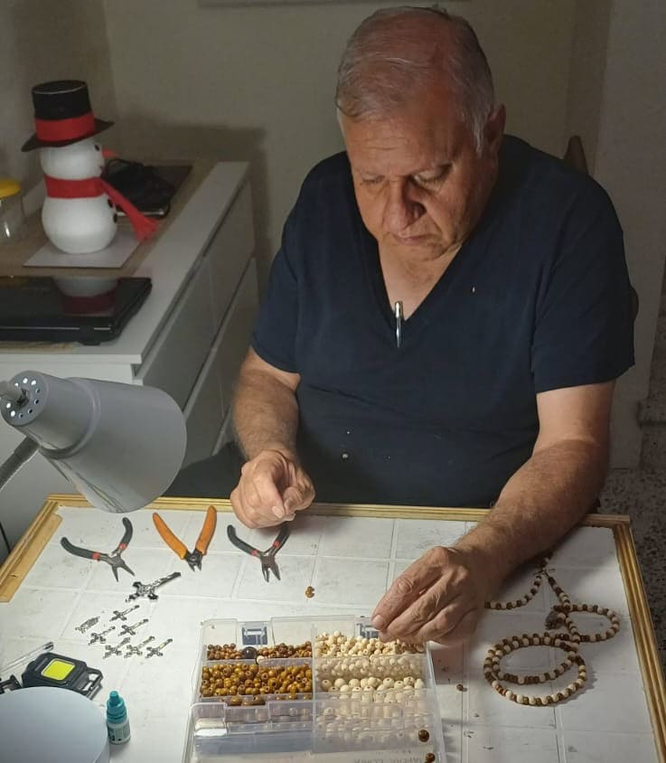 La familia de Luis Galindo tomó fotografías para esta nota promocional de la tienda digital La Visión del Tocar, que él creó para vender los collares, denarios y rosarios que elabora. A causa del glaucoma, perdió más del 90% de su visión, pero mediante el tacto clasifica y arma sus piezas artesanales. Para ir a su tienda en SoyMigrante.com MERCADO, CLIC EN LA IMAGEN.