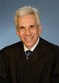 El juez federal de Columbia Randolph D. Moss fue quien suspendió varios artículos de la ley que pretendía acelerar deportaciones, en abierto desafío a normas vigentes.