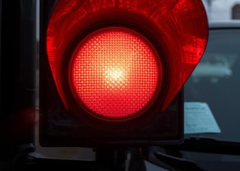 a red light on and a traffic police ticket in a windshield at us street 1