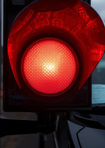 a red light on and a traffic police ticket in a windshield at us street 1