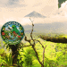 Circular Guatemala megadiversity seal on a lush jungle backdrop with a distant volcano in the background and a dark hand entering from the right.