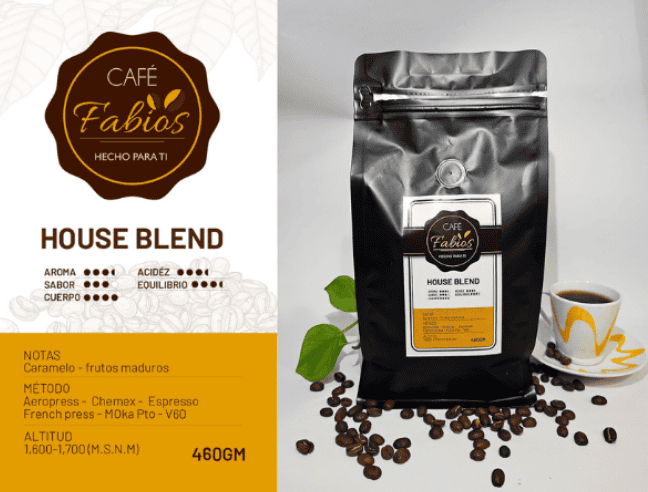 Café Fábio's House Blend coffee bag with label, surrounded by roasted beans and a cup of coffee.