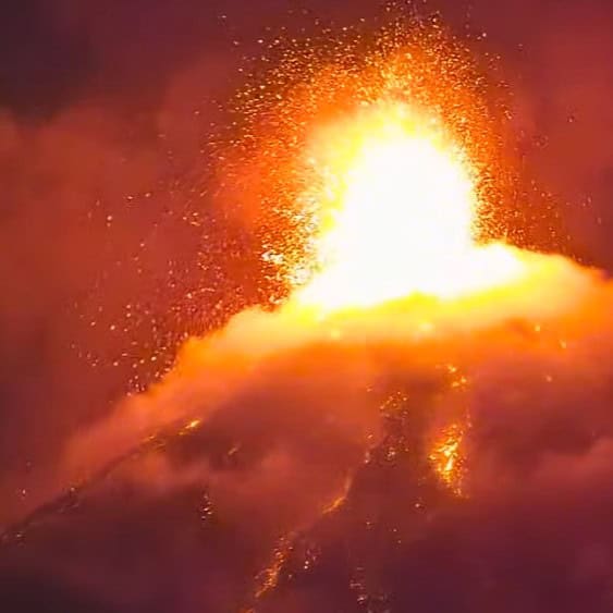 Lava fountain erupting from a volcano with bright orange lava and smoke.