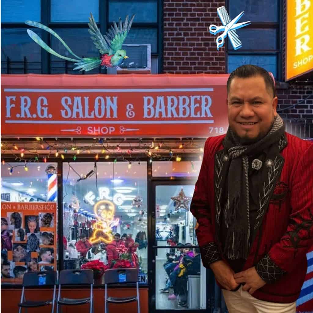 frank lopez migrante emprendedor barber barbero guatemalteco en nueva york originario de cunen quiche 2 – SoyMigrante.com REVISTA Smiling man in a red jacket standing outside a barber shop; a colorful bird flies across the storefront and a scissors-and-comb graphic hovers nearby.