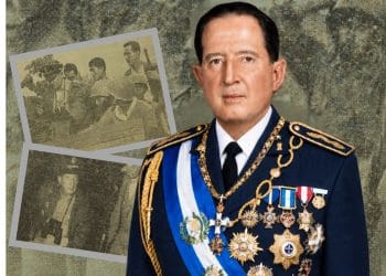 Portrait of a high-ranking military officer in dress uniform with medals and a blue-and-white sash, set against a montage of archival photos behind him.