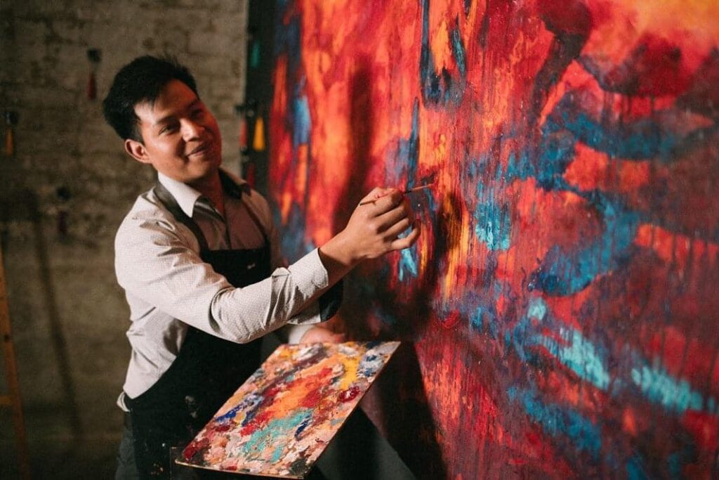 Nehemías Escalante fue captado al momento de pintar una de sus obras en su natal Concepción Chiquirichapa. (Foto Nehemías Escalante) – SoyMigrante.com – SoyMigrante.com