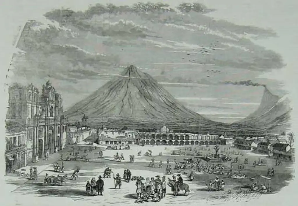 Grabado inglés del año 1850 aproximadamente. Se puede observar el Palacio de los Capitanes Generales, la plaza frente a la Catedral de Antigua y al fondo el imponente Volcán de Agua. Imagen de Creative Commons. – SoyMigrante.com – SoyMigrante.com